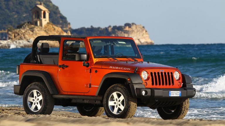 2011 Jeep Wrangler in red by the ocean
